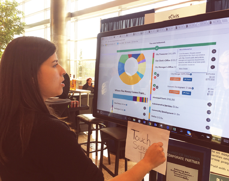 The budget simulation being used on a touch screen.